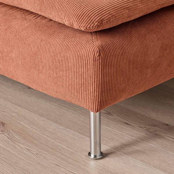 A close-up of a cushioned seat in light brown fabric on a polished metallic leg, showcasing high-quality upholstery.