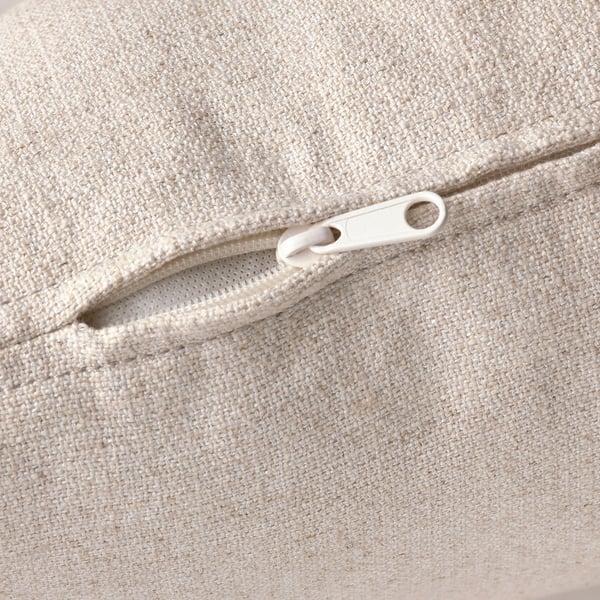 Close-up of a beige zipper on a fabric upholstery, showcasing high-quality finish and design detail.