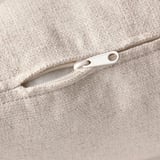 Close-up of a beige zipper on a fabric upholstery, showcasing high-quality finish and design detail.