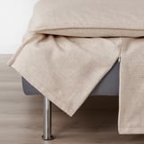 Close-up of SÖDERHAMN sofas zippered, machine-washable cover with light beige fabric.