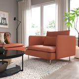 Rust-colored SÖDERHAMN armchair by window, perfect for relaxing.