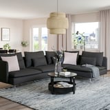 Modern living room with SÖDERHAMN sofa, coffee table, vase, lamp, city view, pink curtains.