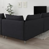 L-shaped grey SÖDERHAMN sofa in minimalist living room with tv, plant, and rug.