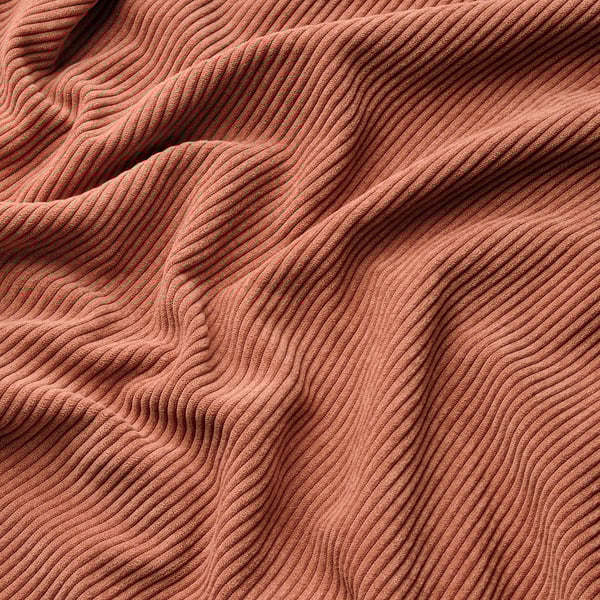Red, textured fabric with parallel ridges, appears soft and durable.