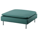 Large square green footrest with chrome legs. Modern design with cushioned top.
