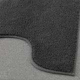 Close-up of dark grey plush mat with thick, soft cotton pile and textured latex backing, displayed on a flat surface.