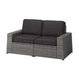 Modern outdoor loveseat, grey wicker, black cushions, modular design for versatile seating.