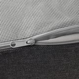 Close-up of high-quality zipper on durable, textured grey outdoor sofa cushion.