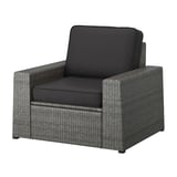 A SOLLERÖN grey wicker outdoor armchair with dark grey cushions, designed for comfort and durability.