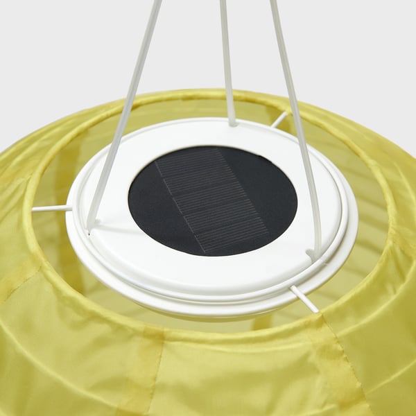 Solar-powered lamp with yellow shade and white poles.