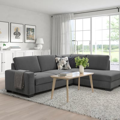 Grey SÖRVALLEN sofa with wooden legs in minimalist living room.