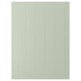A green STENSUND cabinet door with vertical grooves. Its a rectangular shape made of fibreboard, smooth to touch.