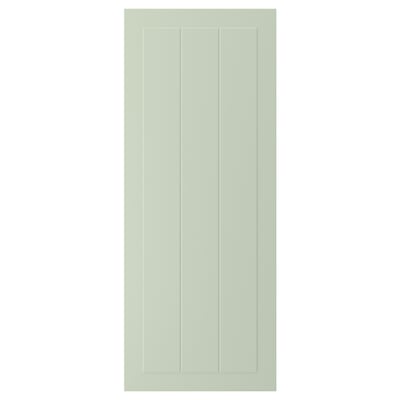 A green STENSUND cabinet door with a grooved panel design, made from fibreboard with a smooth, easy-to-clean finish.