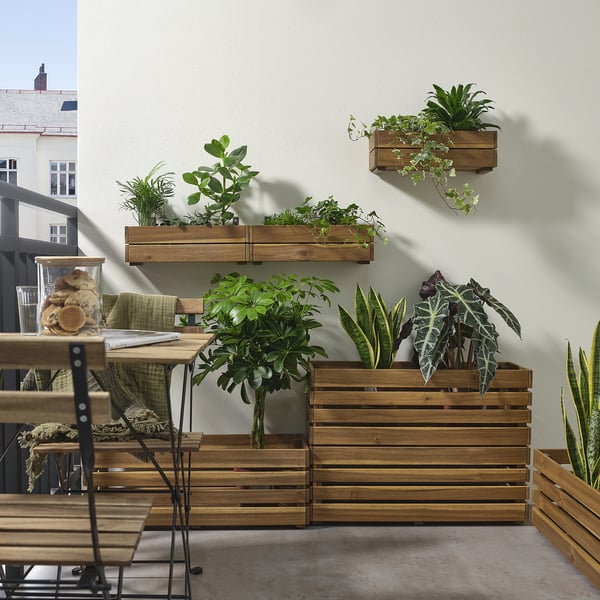 STJÄRNANIS wooden plant boxes on balcony, plants vary in size, acacia wood, rectangular shape, stacked vertically and horizontally.