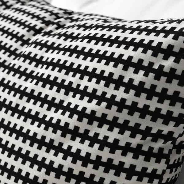 Black and white patterned throw pillow with intricate geometric design, showcasing high-quality fabric and detailed stitching.