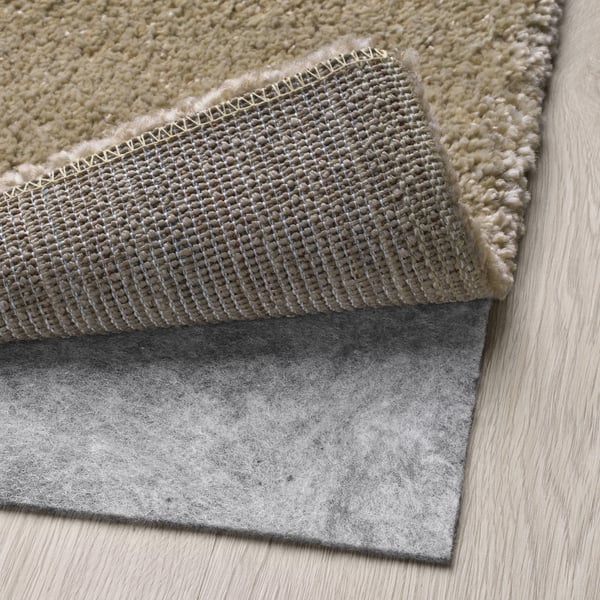 Rug with thick, soft pile, anti-slip mat underneath. Ideal for comfort and safety.