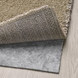 Rug with thick, soft pile, anti-slip mat underneath. Ideal for comfort and safety.