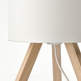 A sleek, modern lamp with a white fabric shade and ash wood tripod legs.