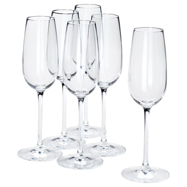 Six clear STORSINT crystal wine glasses, five grouped, one separate. Long stems, broad bowls, shiny, elegant design.