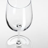 A clear, empty wine glass shown in close-up, highlighting its smooth stem and shiny, transparent bowl.