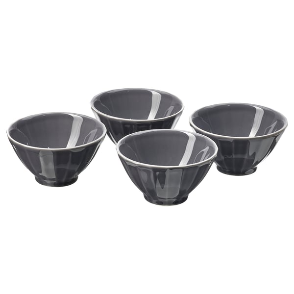 Four black ceramic bowls with white floral patterns, arranged in a square.