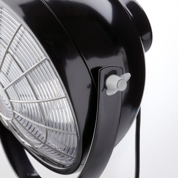 Black adjustable lamp with rounded design and metal grill, showcasing high-quality materials and modern aesthetic.