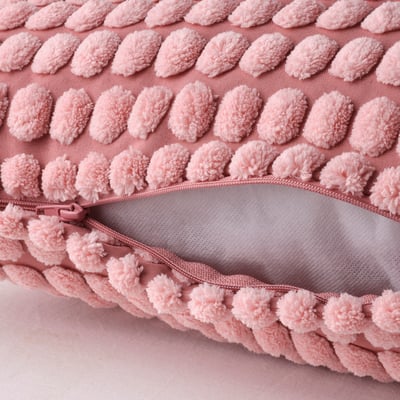 Light pink cushion cover, zipper opening, soft textured pattern, recycled polyester.
