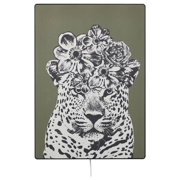 SYMFONISK picture frame speaker with leopard print and flowers; black and white design on green background; fabric cover and plastic frame.