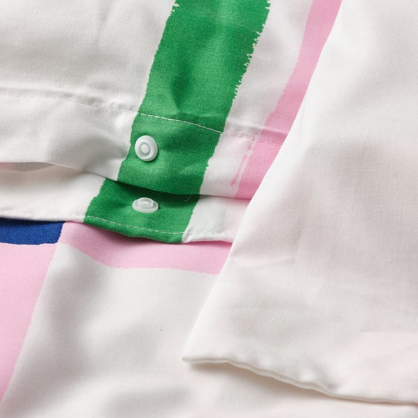 Close-up of a multicolour duvet cover with hand-drawn check pattern and plastic press-stud closure.