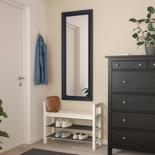 TOFTBYN mirror, large & safe with safety film, above white shoe rack, blue garment left, dark dresser right.