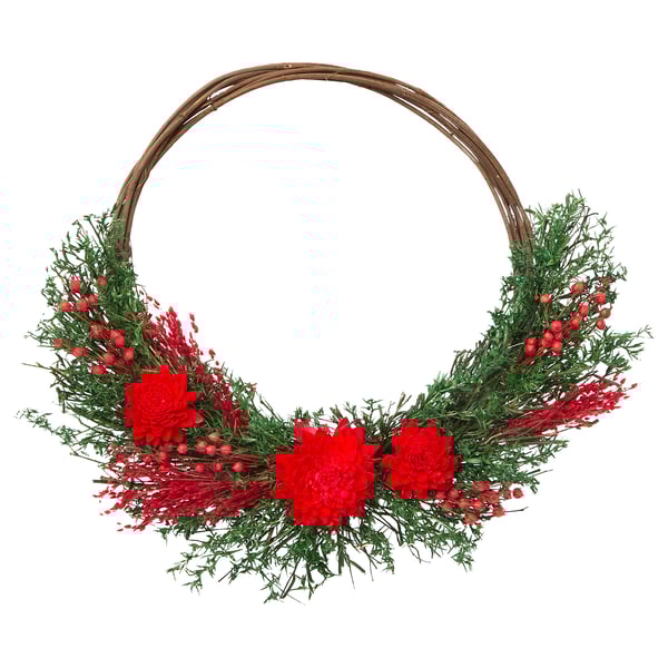 Circular wreath with red flowers, green foliage, white berries on brown base.