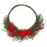 Circular wreath with red flowers, green foliage, white berries on brown base.