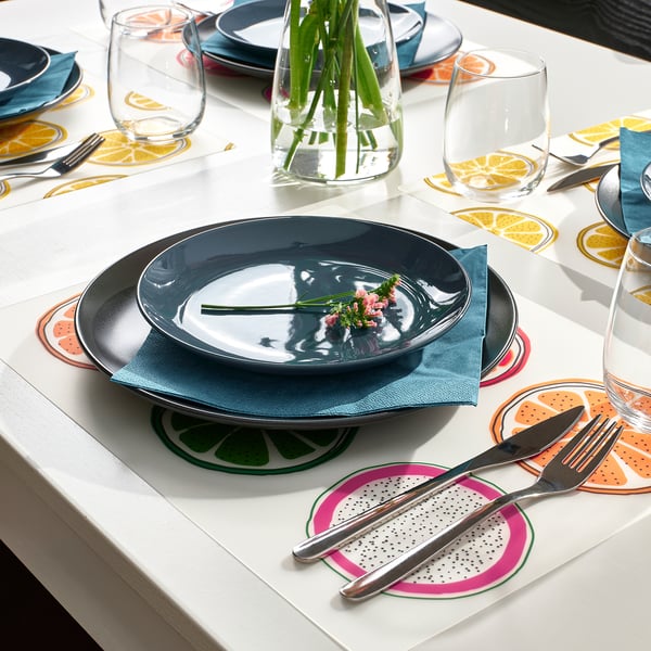 Bright place mats in vivid patterns enhance table setting, creating cheerful atmosphere. Made of durable plastic, easy to clean.