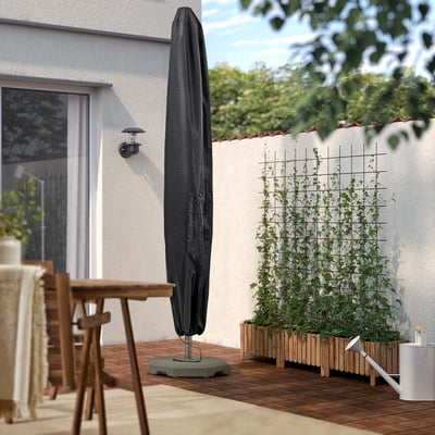 Umbrella with TOSTERÖ cover on wooden deck.