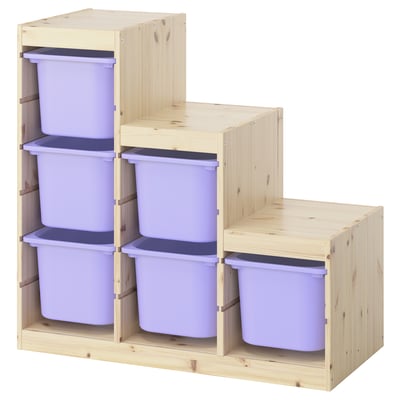 A wooden TROFAST storage unit with light purple bins, designed for kids to organize toys.