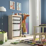 Kids room featuring TROFAST light pine storage unit with white boxes. Bright rug, colorful toys, and simple decor.