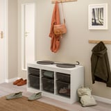 White TROFAST storage unit, large, holds baskets & items, below coat rack.
