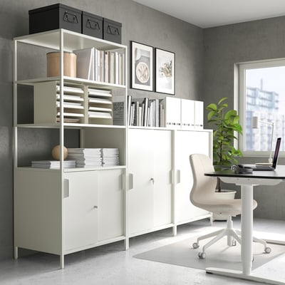 Modern home office with white TROTTEN cabinet, shelves, and desk, efficient workspace with storage.