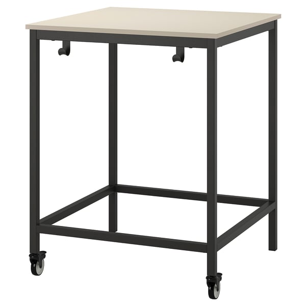 A TROTTEN beige desk on casters with a black metal frame.