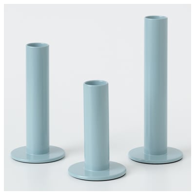 Three blue candles in varying holders by hagberg siblings.