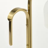 Golden metal lamp with frosted glass shade, high-quality finish, and sleek handle.