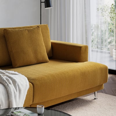Mustard yellow UPPÅKRA sofa, modern design, comfortable with large cushions, positioned by a large window.