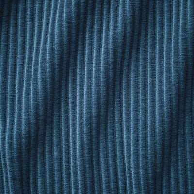 A close-up of a dark blue, textured fabric on a sofa, showcasing its quality and weave.