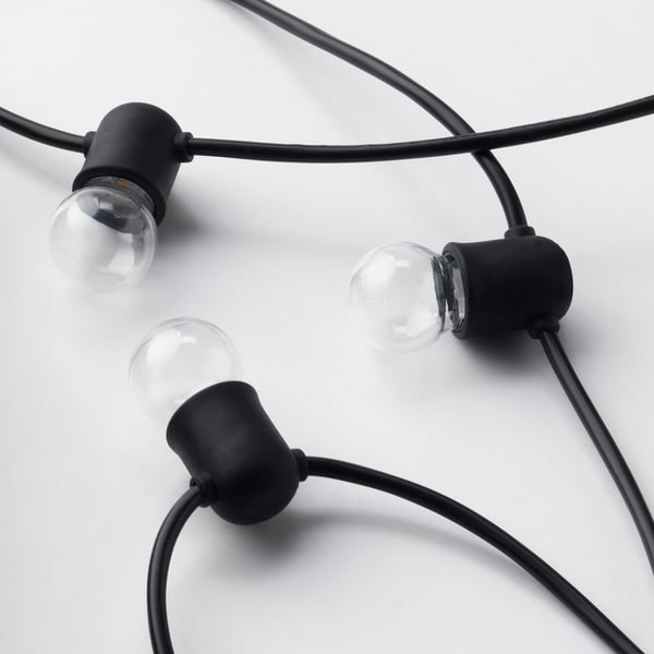 Black string lights with three bulb sockets. Bulbs are spherical and transparent. High-quality materials, neatly arranged.