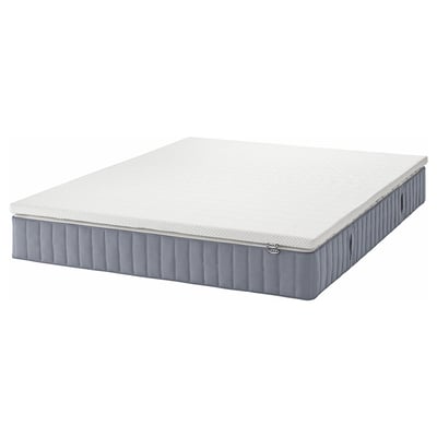 Depicts a grey VALEVÅG pocket spring mattress, designed for mid to heavier sleepers, featuring 5 comfort zones and breathable edges.