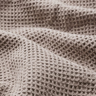 Textured, light grey-brown towel hangs neatly, with fringe edges; 80% cotton, 20% viscose.
