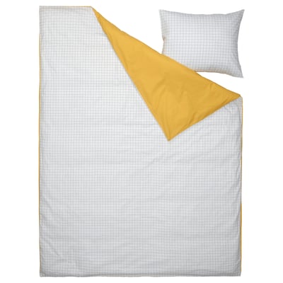 White cotton pillow, folded blanket; checkered pattern.