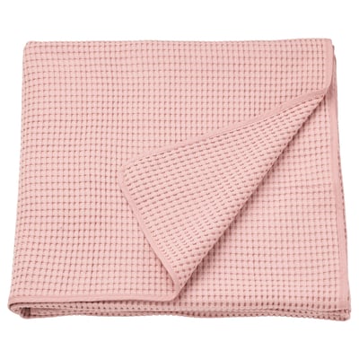 A neatly folded VÅRELD bedspread in light pink, made of 100% cotton with a textured waffle design.