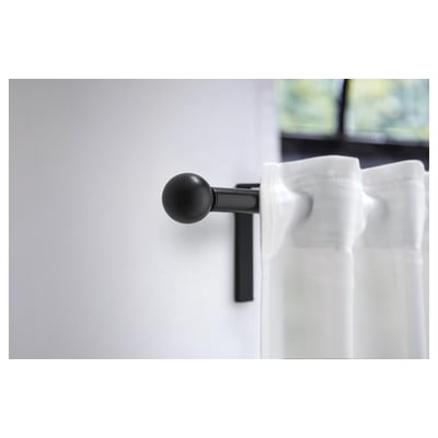 Two black, spherical VÄSENTLIG finials made from recycled plastic with a matte finish and metallic screws.