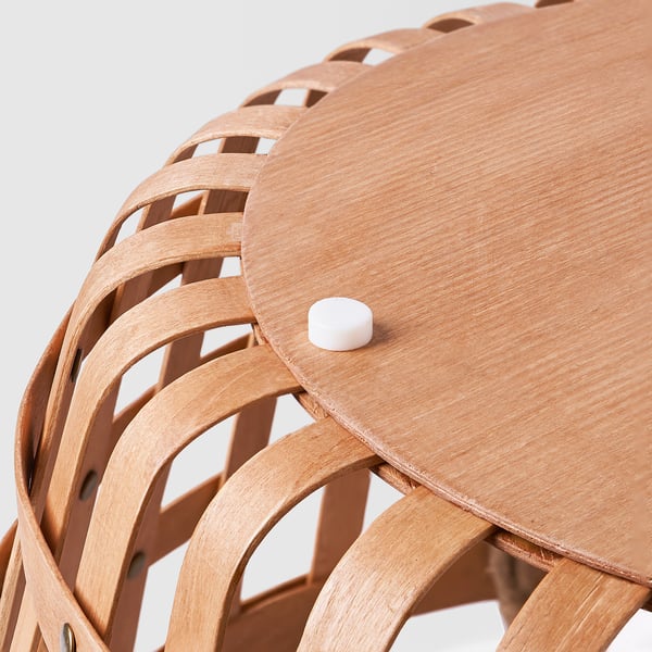 Handwoven wooden stool with curved legs and white plastic foot protector, ensuring stability and scratch-free surfaces.